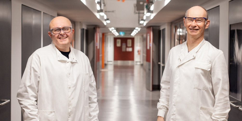 Two men smiling